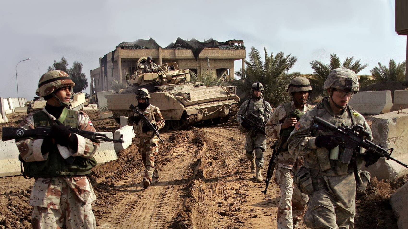 RAMADI, IRAQ - JANUARY 16:  Iraqi Army troops patrol with U.S. soldiers from B Company, 1st Battalion, 26th Infantry Regiment through Ramadi January 16, 2007 in Iraq's Anbar province. Ramadi, with daily fighting between American forces and insurgents, has one of the highest casualty rates in Iraq.  (Photo by John Moore/Getty Images)